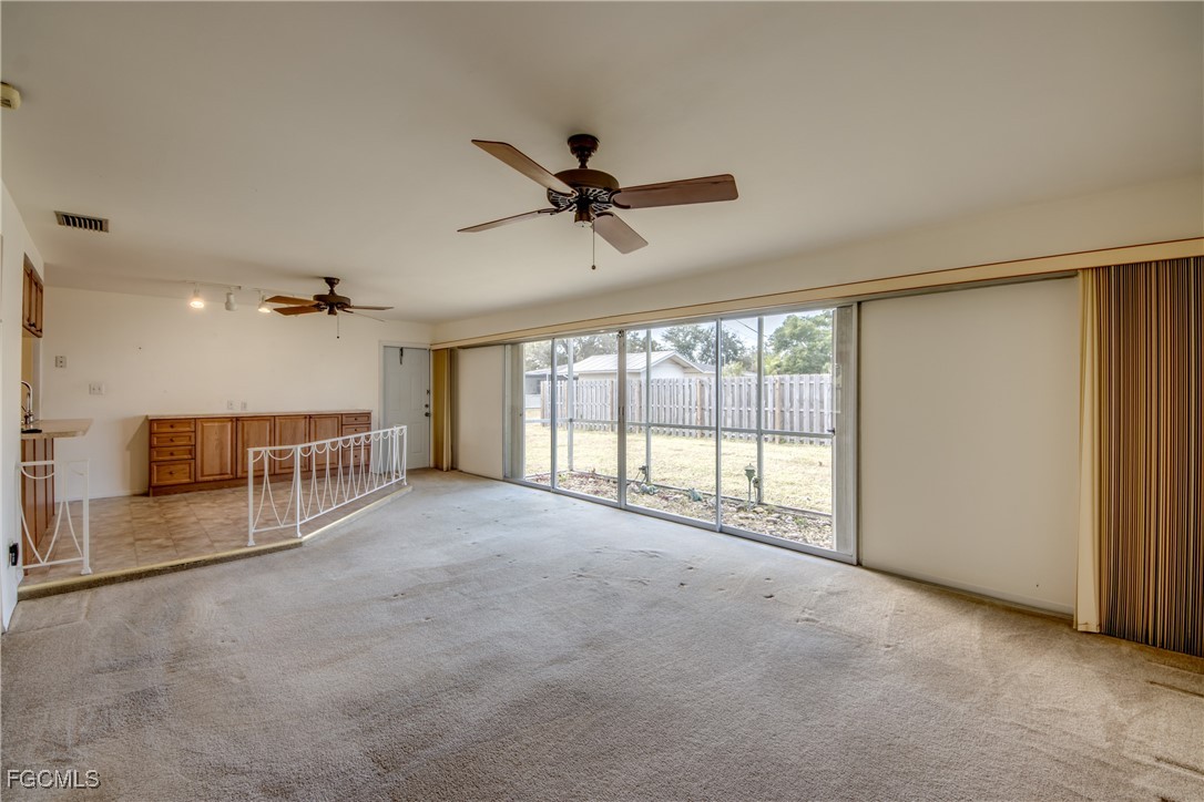 3728 Deleon Street Fort Myers, FL 33901 - Photo 29 of 50 an empty room with windows and ceiling fan view