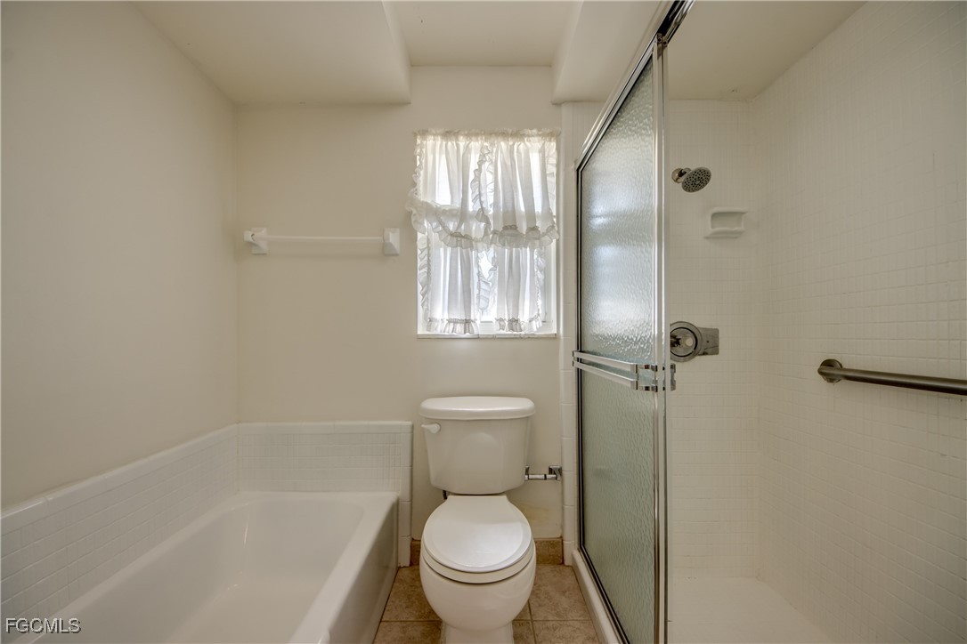 3728 Deleon Street Fort Myers, FL 33901 - Photo 37 of 50 a white toilet sitting next to a bath tub shower