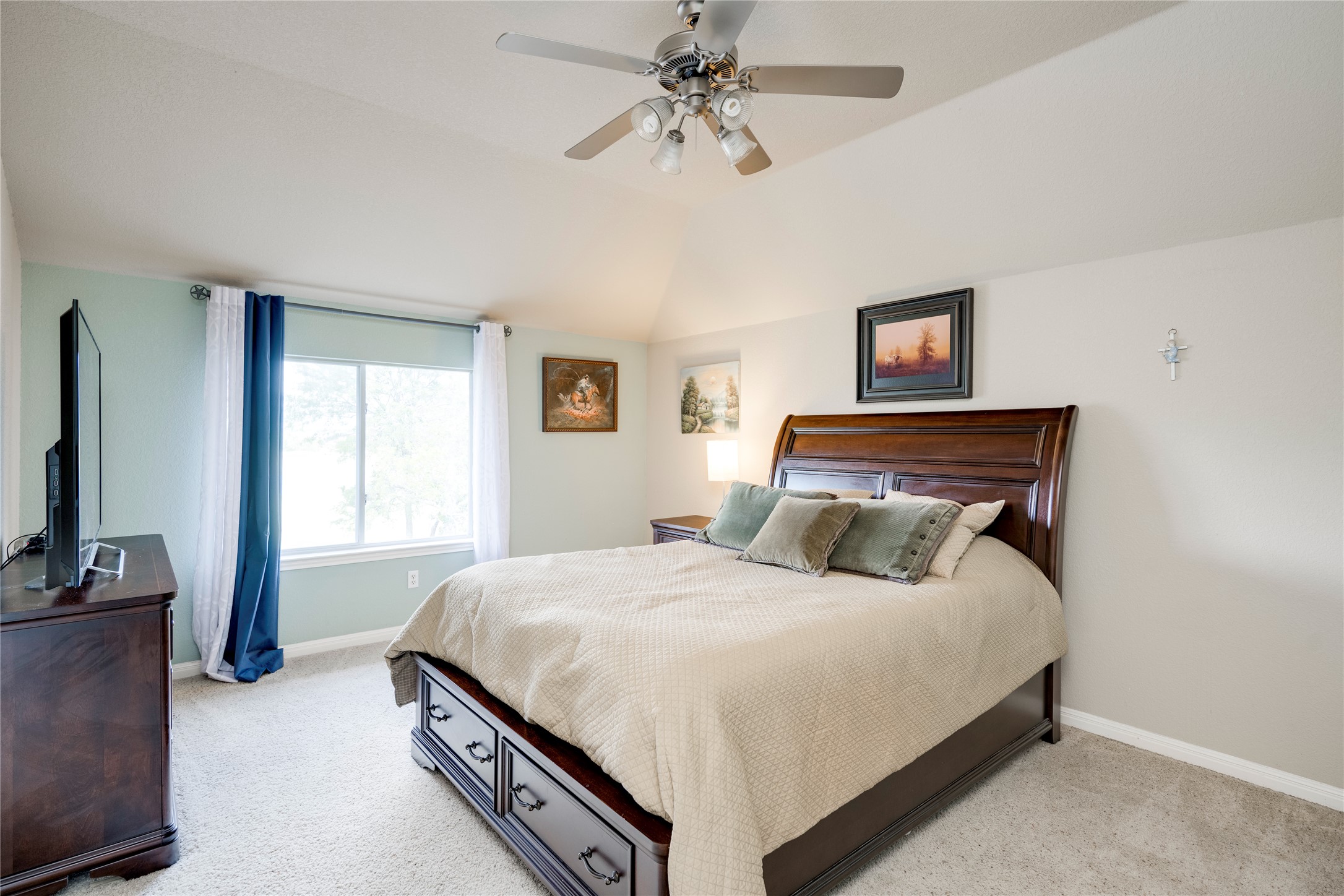 11332 Terrace Meadow Way Manor, TX 78653 - Photo 18 of 37 a bedroom with a bed and a flat screen tv