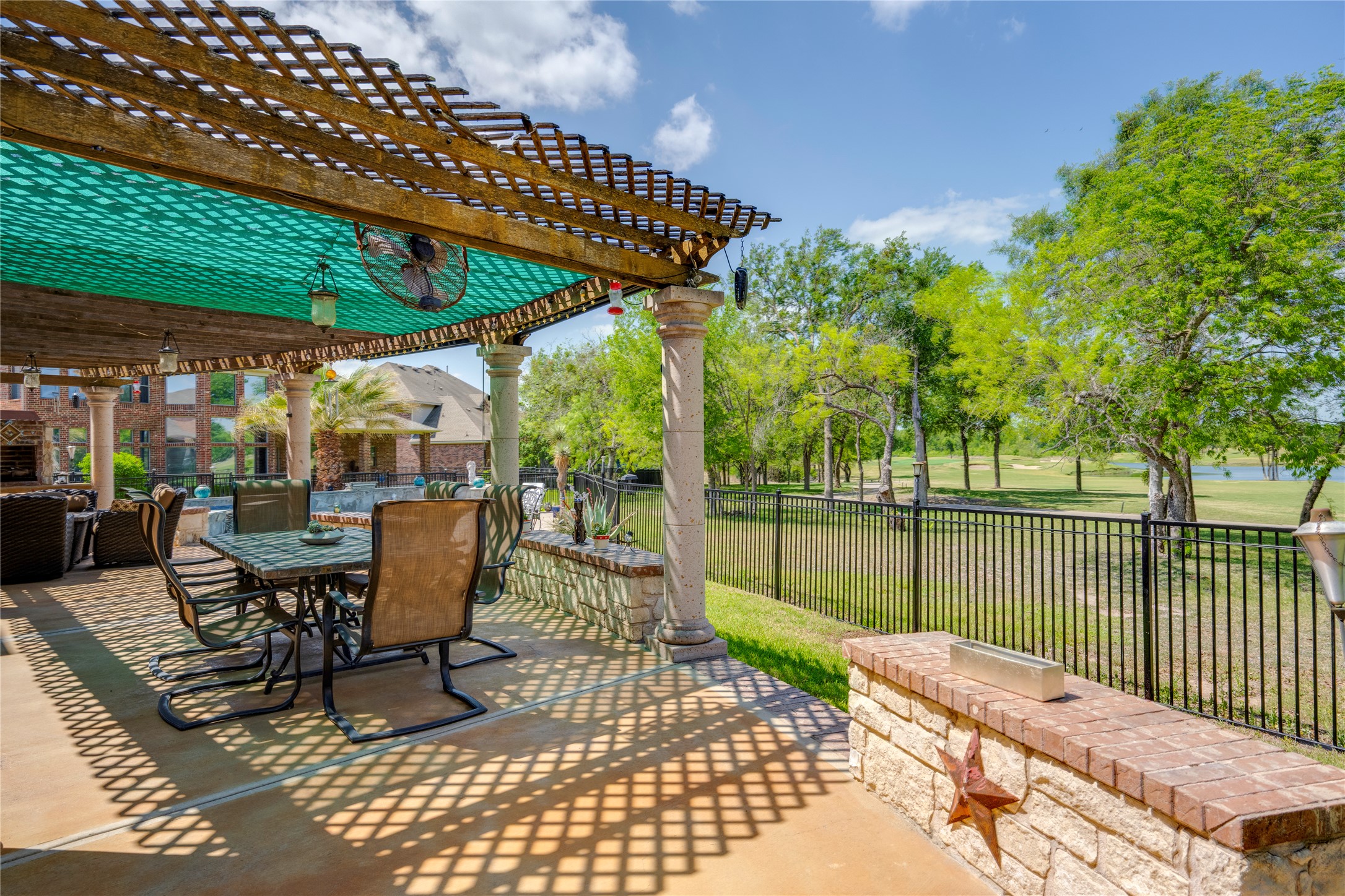 11332 Terrace Meadow Way Manor, TX 78653 - Photo 31 of 37 a patio with water view fountain with a table and chairs under an umbrella