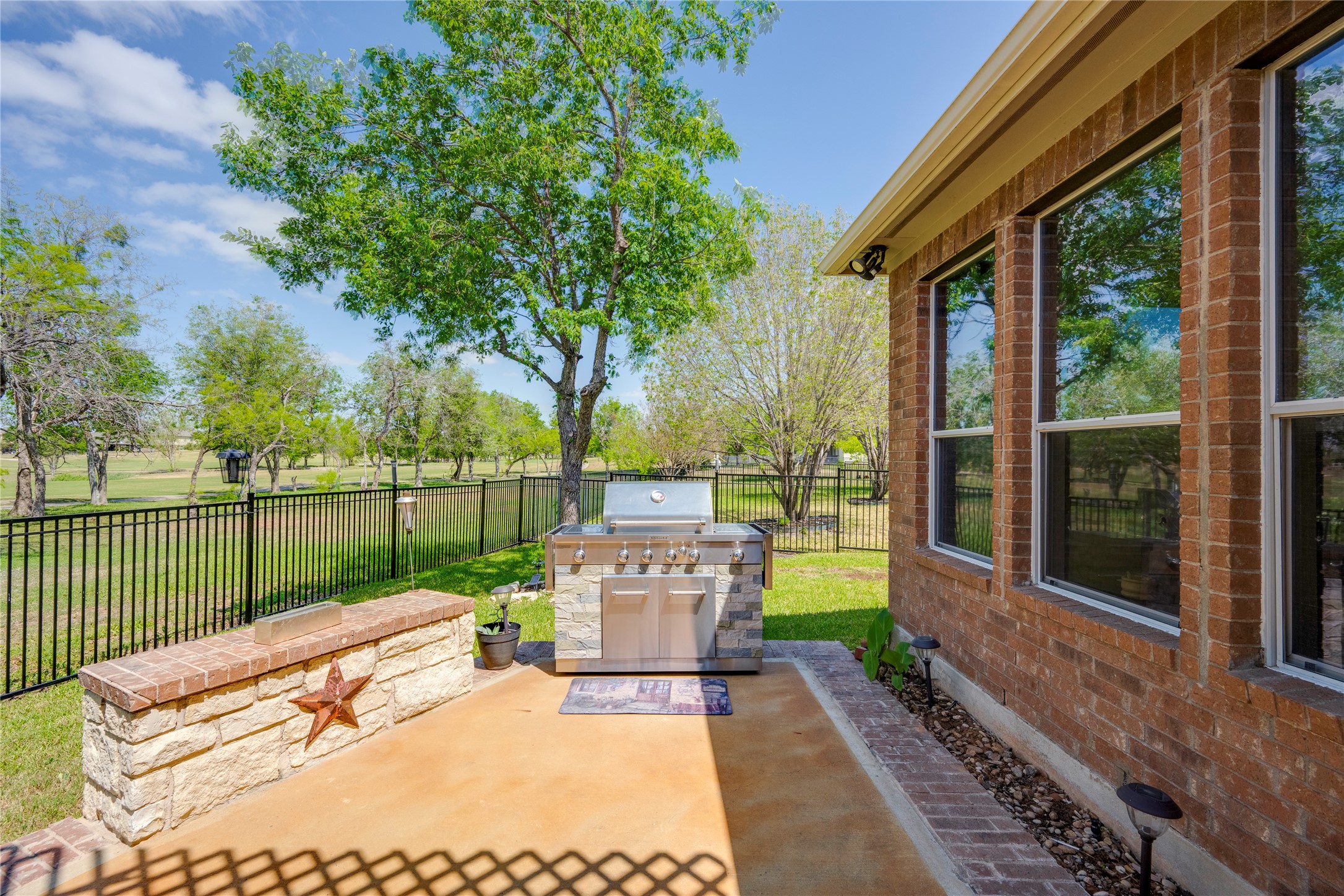11332 Terrace Meadow Way Manor, TX 78653 - Photo 32 of 37 a view of a patio with a table chairs and a backyard