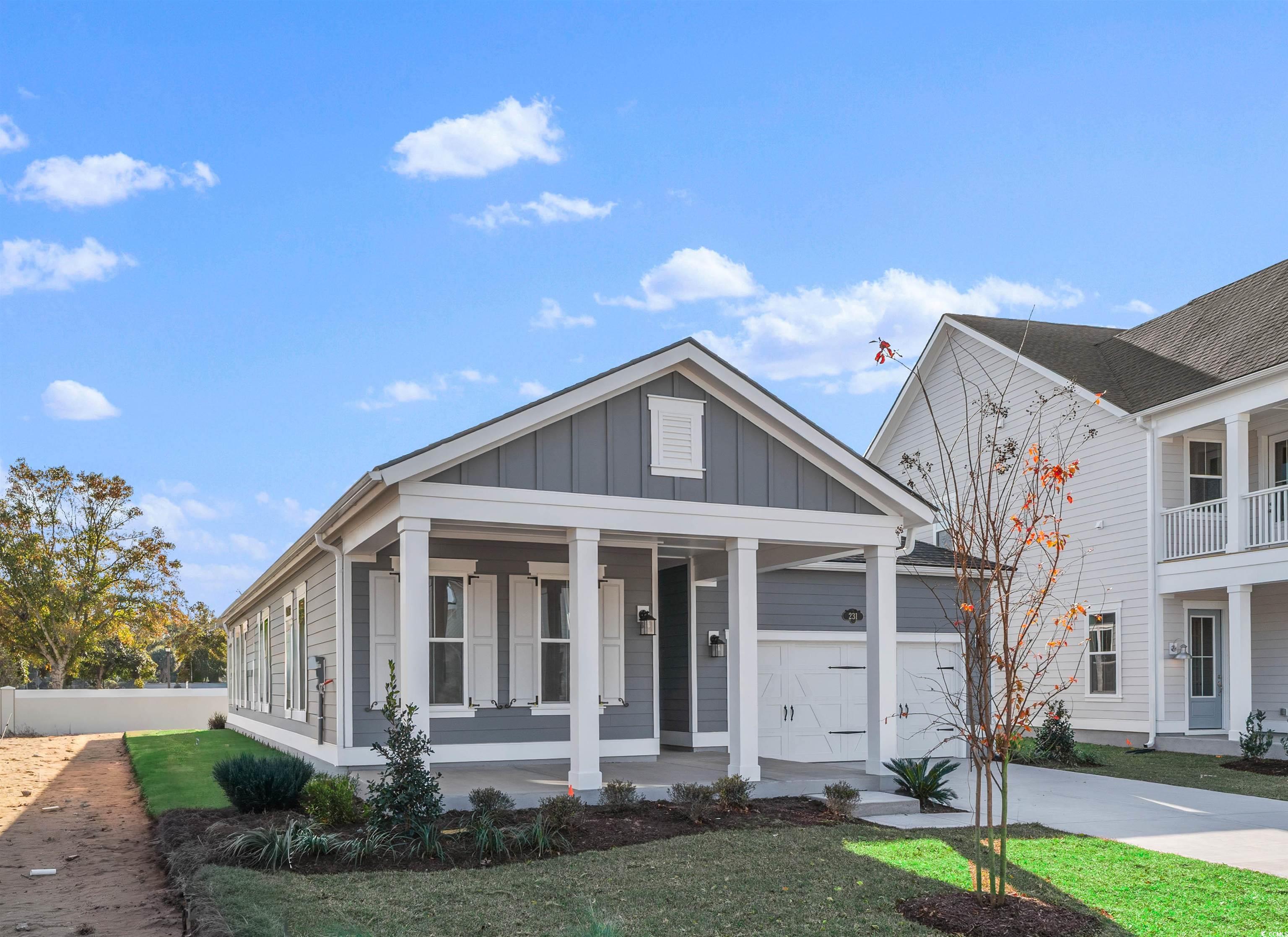 231 Atlantic Breeze Street Myrtle Beach, SC 29572 - Photo 2 of 21 View of front of property with board and batten siding, a porch, and concrete driveway
