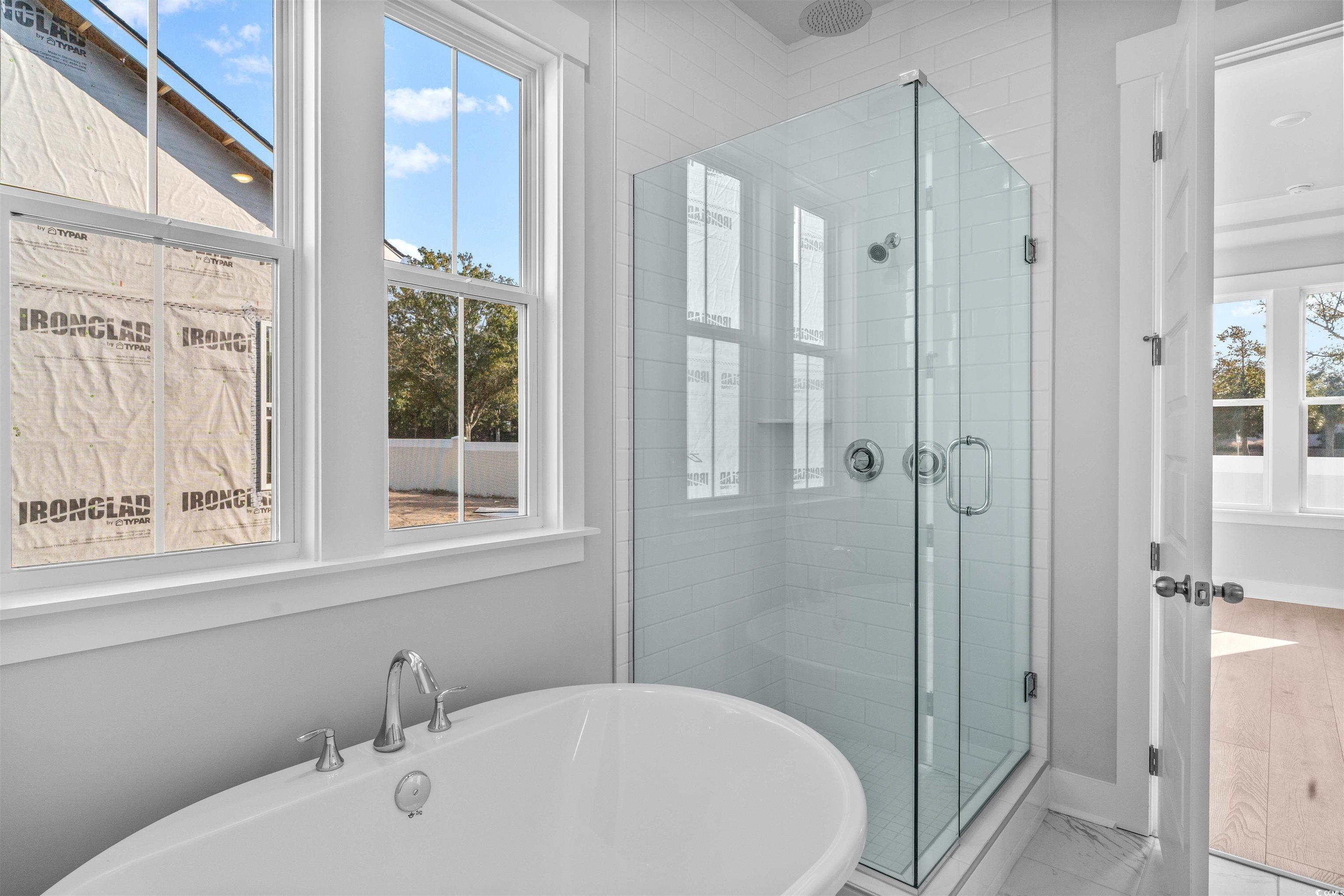 231 Atlantic Breeze Street Myrtle Beach, SC 29572 - Photo 21 of 21 Bathroom featuring a freestanding bath, a stall shower, and marble look tiles