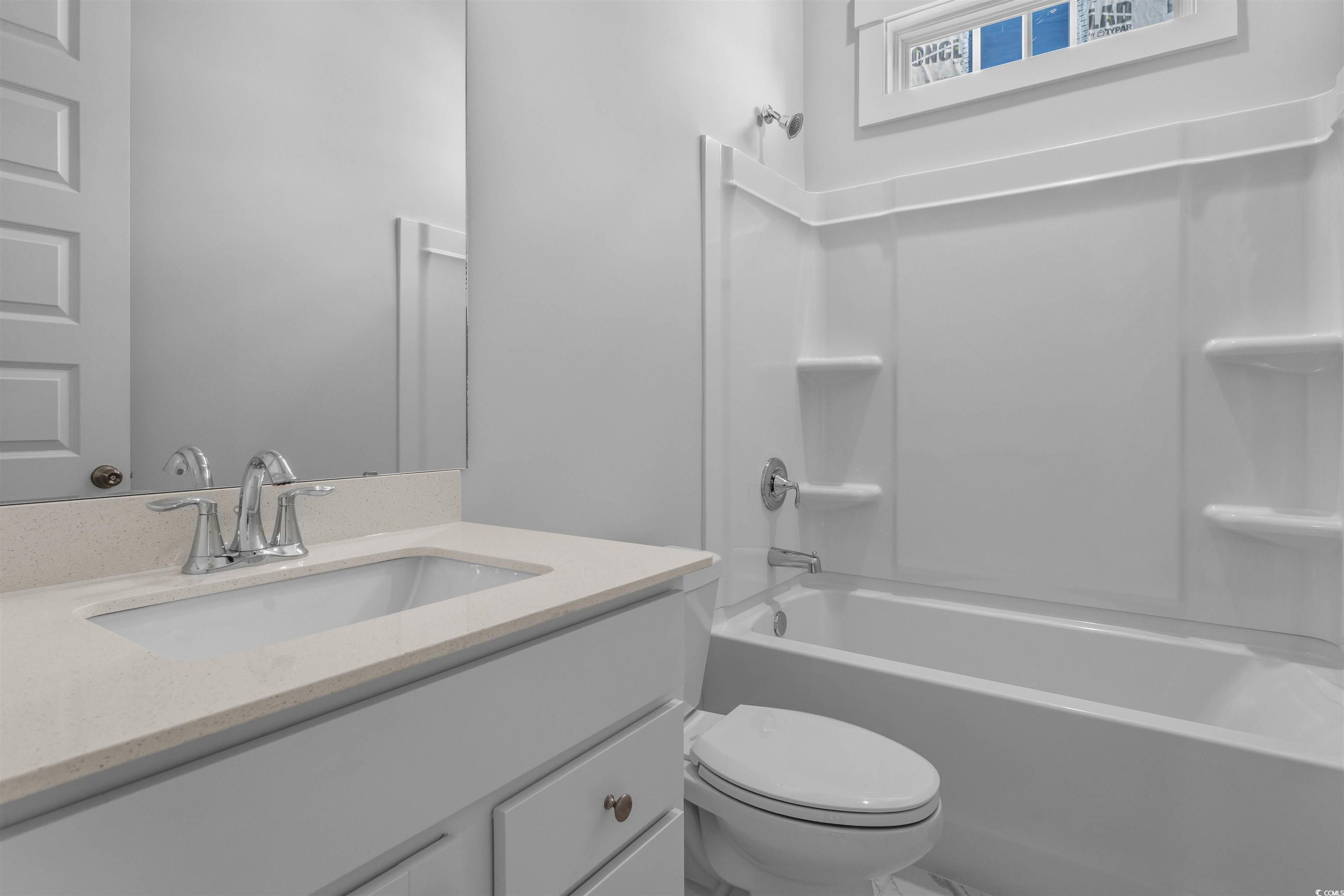 231 Atlantic Breeze Street Myrtle Beach, SC 29572 - Photo 5 of 21 Full bathroom featuring vanity and shower combination