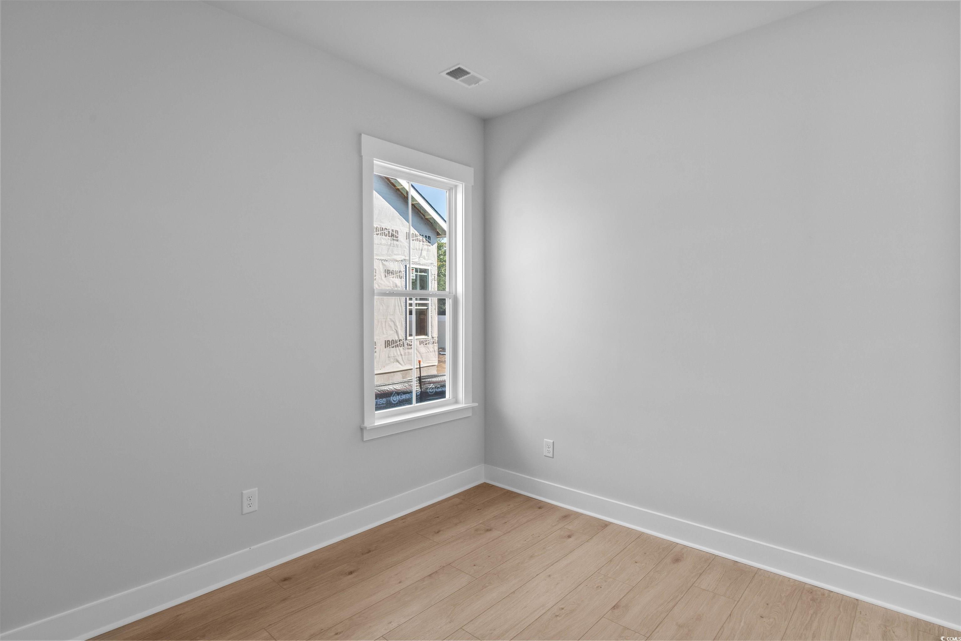 231 Atlantic Breeze Street Myrtle Beach, SC 29572 - Photo 8 of 21 Unfurnished room with baseboards and light wood-style flooring