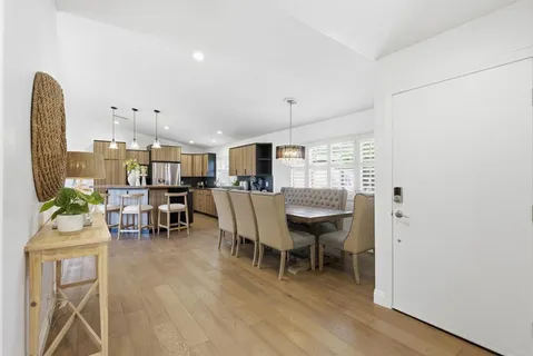 a dining room with furniture and wooden floor