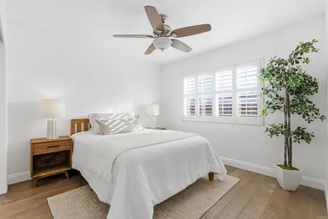 a bedroom with a bed and a potted plant