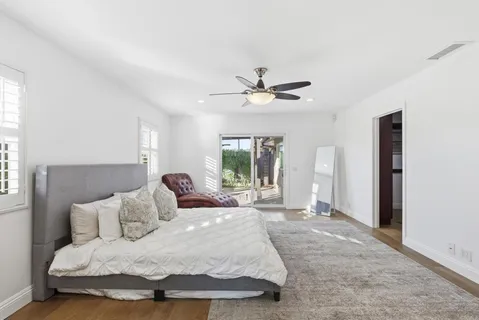 a bedroom with a large bed and a window