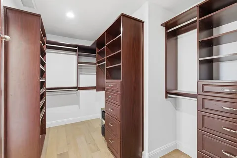 a view of walk in closet with empty racks