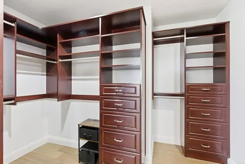 a view of walk in closet with empty racks