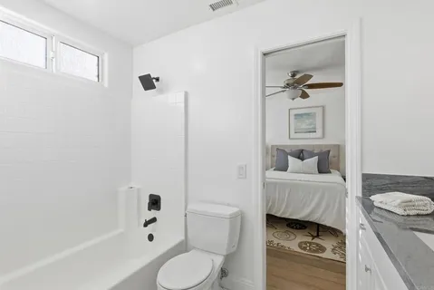 a bathroom with a toilet sink a shower and bathtub