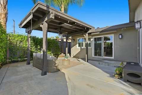 a patio with a table and chairs under an umbrella