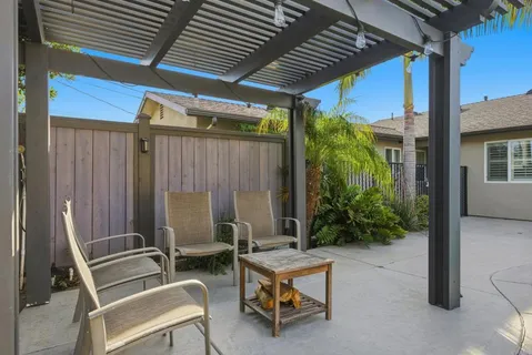 a balcony with furniture and a potted plant