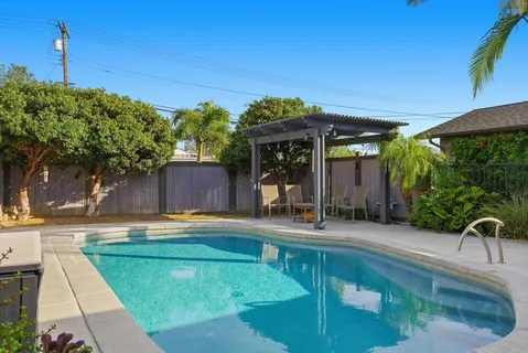 a swimming pool with outdoor seating and yard