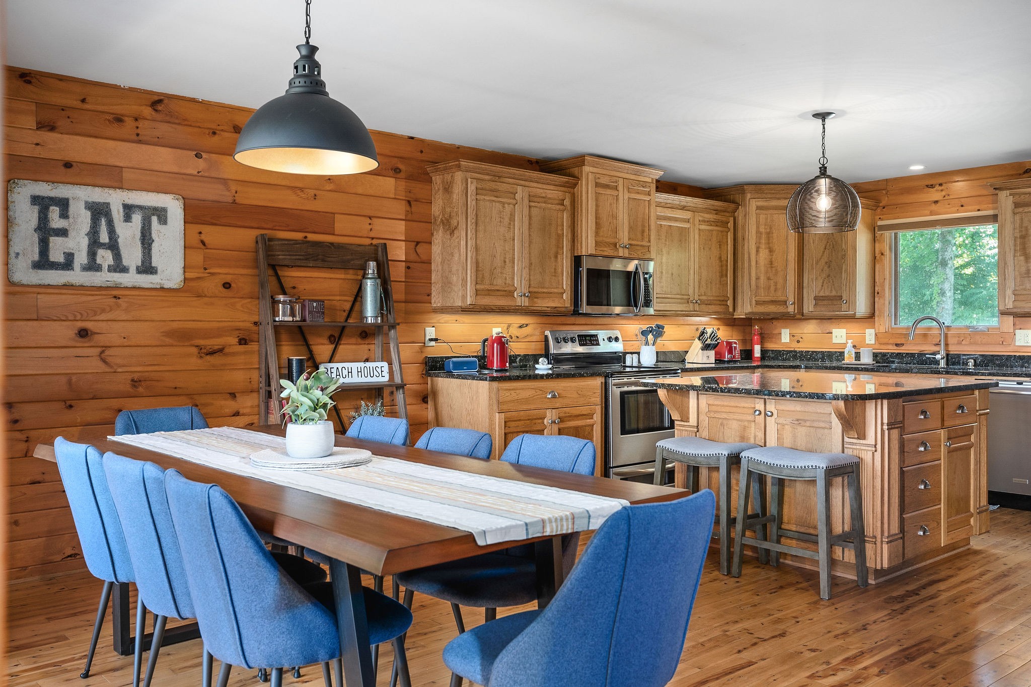 4415 Coconut Ridge Road Smithville, TN 37166 - Photo 13 of 52 a kitchen with stainless steel appliances wooden floor dining table and chairs