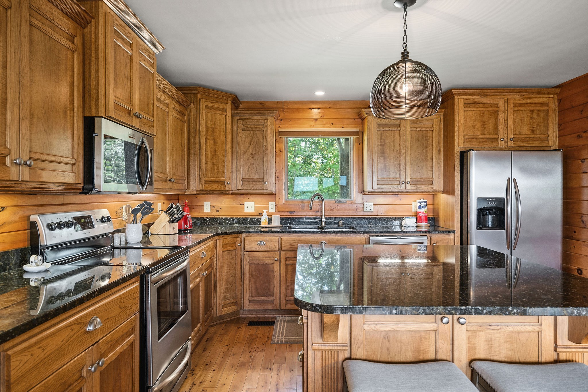 4415 Coconut Ridge Road Smithville, TN 37166 - Photo 17 of 52 a kitchen with stainless steel appliances granite countertop a sink a stove and a refrigerator
