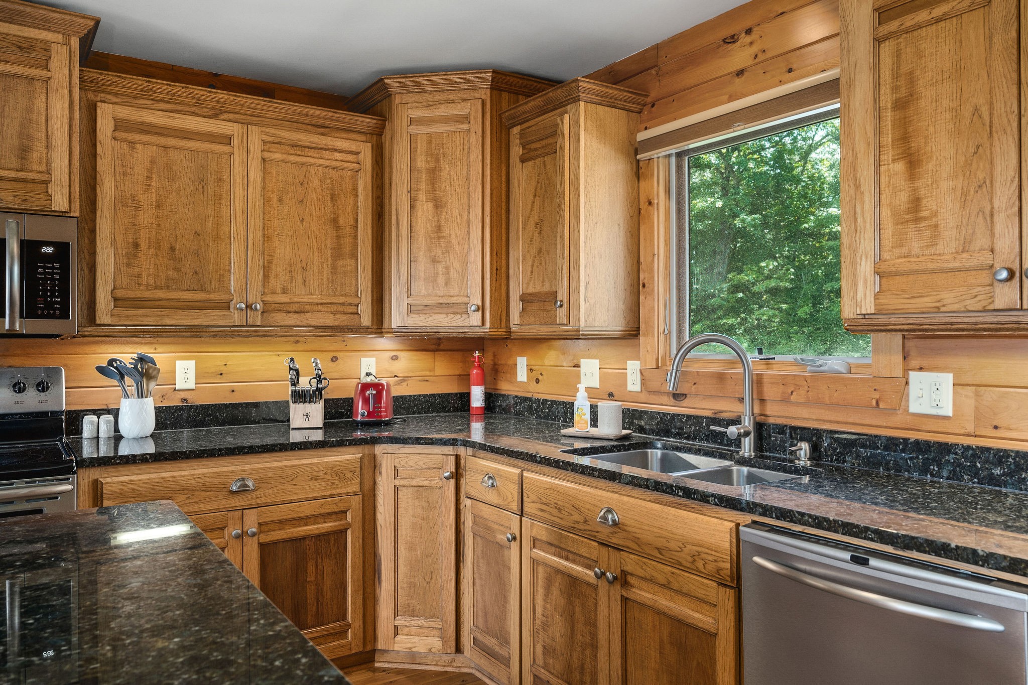 4415 Coconut Ridge Road Smithville, TN 37166 - Photo 18 of 52 a kitchen with stainless steel appliances granite countertop a sink a stove a counter space and cabinets