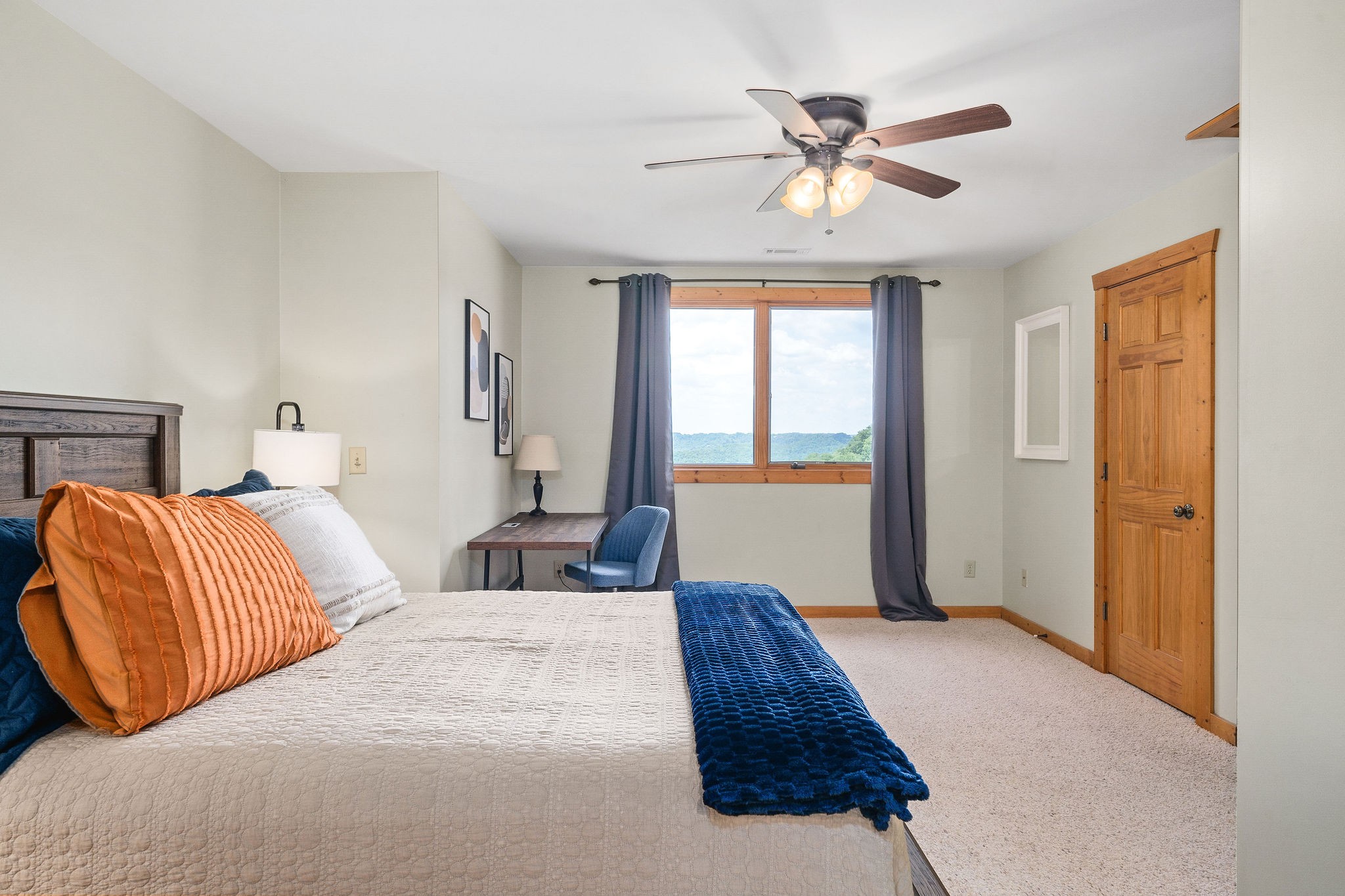 4415 Coconut Ridge Road Smithville, TN 37166 - Photo 37 of 52 a bedroom with a large bed and a chandelier