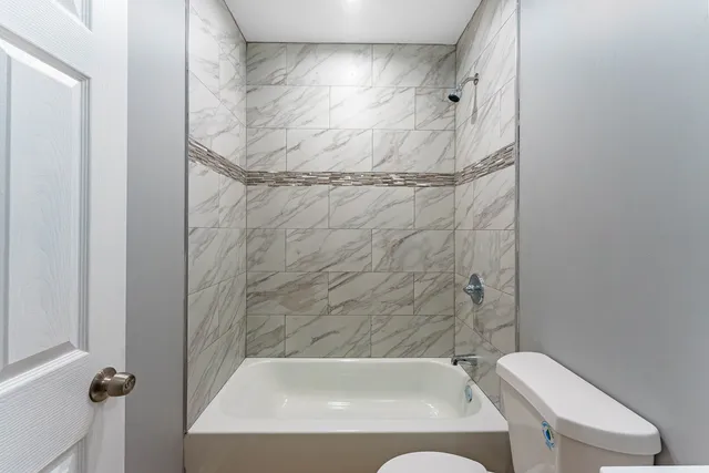 a bathroom with a tub and a shower