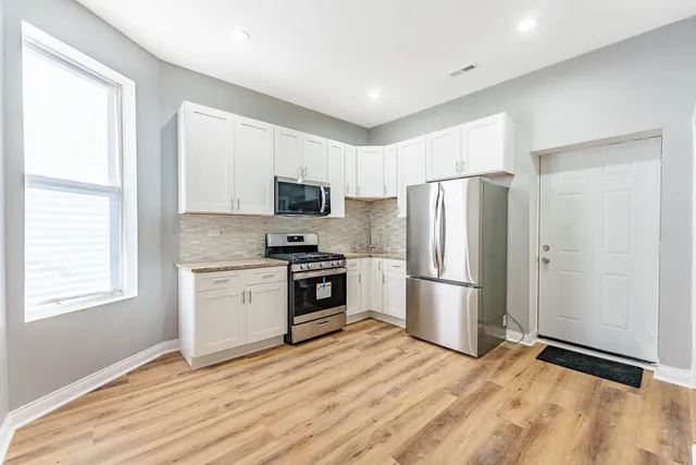a kitchen with a refrigerator stove and microwave