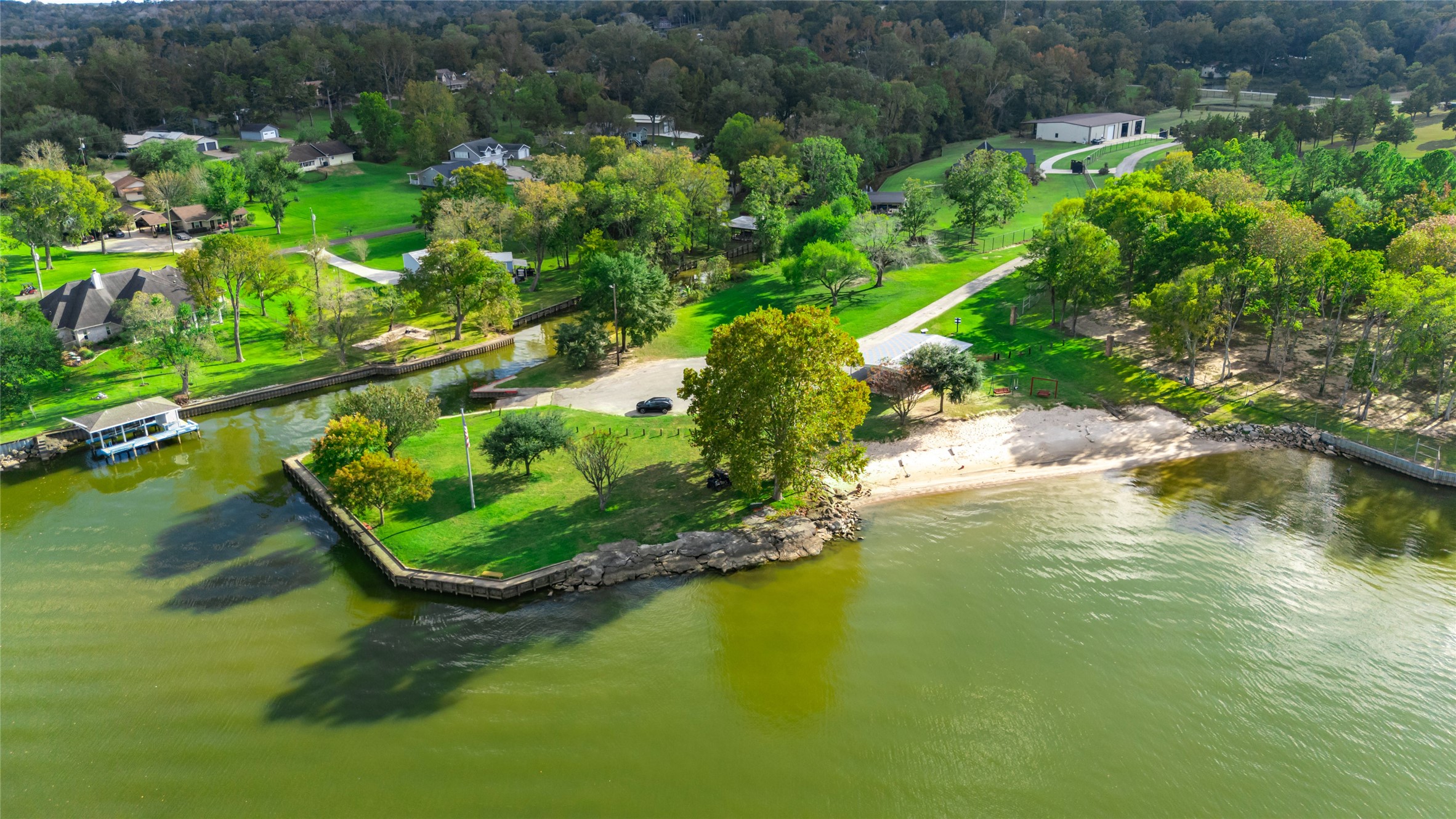 590 Cove Loop Coldspring, TX 77331 - Photo 31 of 36 Aerial view of neighborhood amenities. Park includes beach with swimming spot, private boat launch, pavilion, and fishing areas.