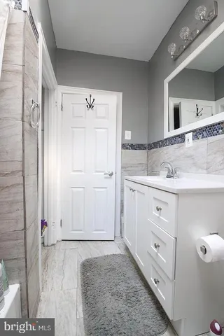 a bathroom with a sink a toilet and a mirror