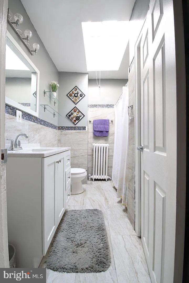 83 North State Road Upper Darby, PA 19082 - Photo 13 of 27 a bathroom with a sink a toilet and a mirror