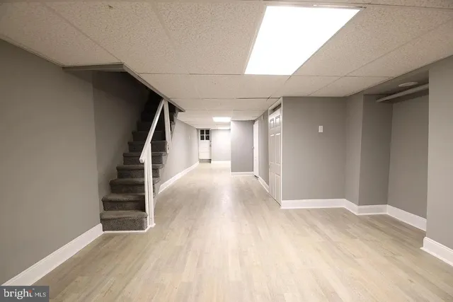 a view of hallway with stairs and wooden floor