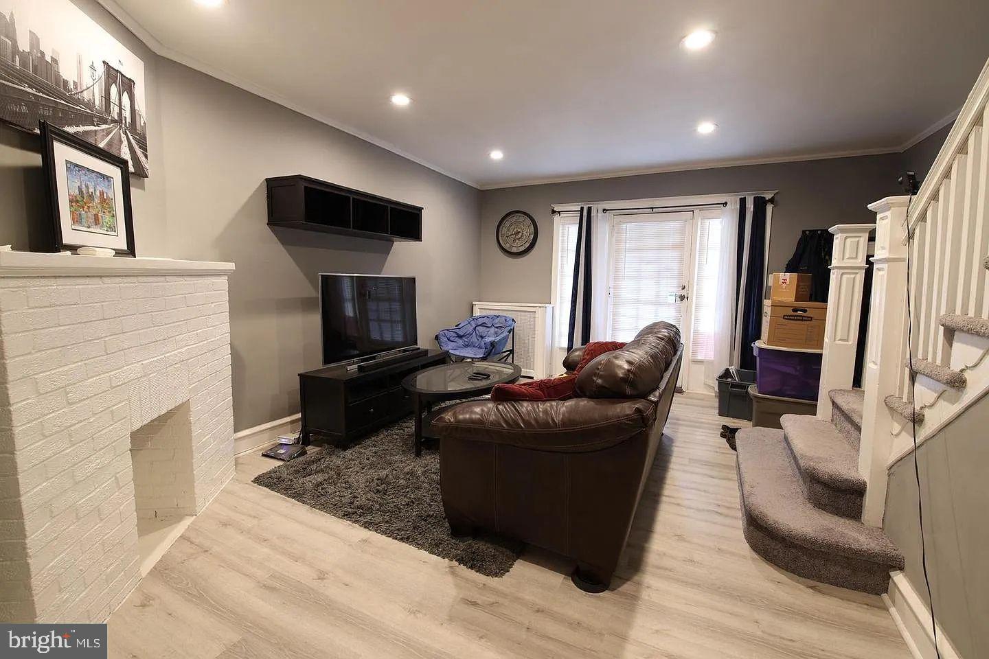 83 North State Road Upper Darby, PA 19082 - Photo 3 of 27 a living room with furniture a fireplace and a flat screen tv