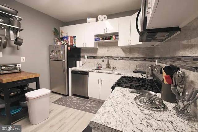 a kitchen with a sink stove and refrigerator