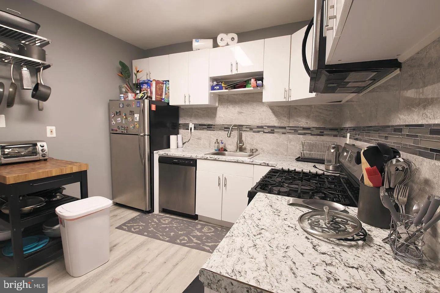83 North State Road Upper Darby, PA 19082 - Photo 5 of 27 a kitchen with a sink stove and refrigerator