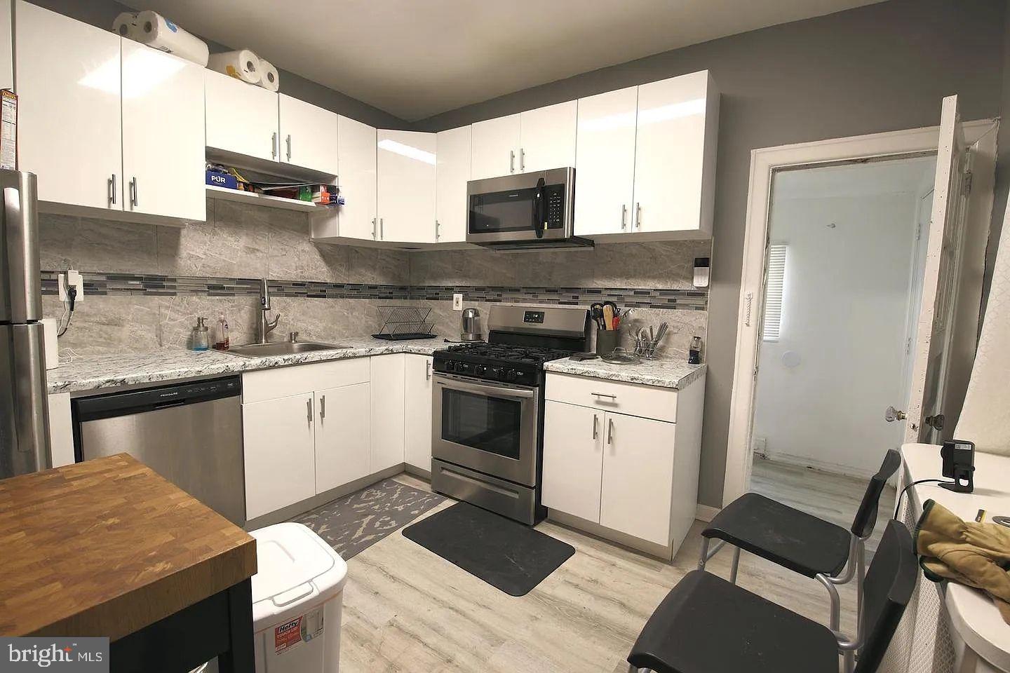 83 North State Road Upper Darby, PA 19082 - Photo 6 of 27 a kitchen with a sink stove and refrigerator
