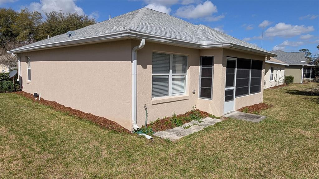 10912 Southwest 69th Circle Ocala, FL 34476 - Photo 2 of 11 a front view of a house with a yard