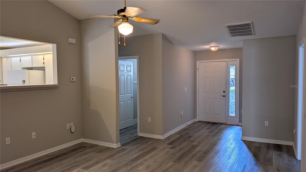 10912 Southwest 69th Circle Ocala, FL 34476 - Photo 3 of 11 wooden floor in an empty room with a window