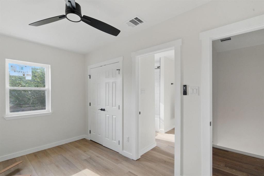 903 North Miller Street Decatur, TX 76234 - Photo 13 of 15 Unfurnished bedroom with light wood-style floors, a closet, and a ceiling fan