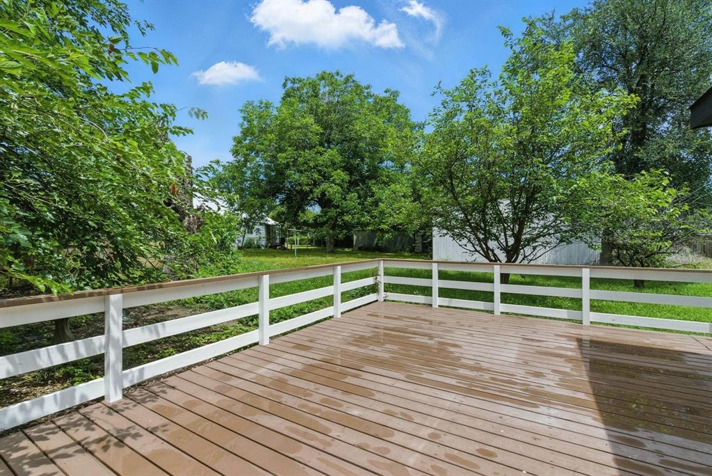 903 North Miller Street Decatur, TX 76234 - Photo 4 of 15 Wooden deck featuring a yard