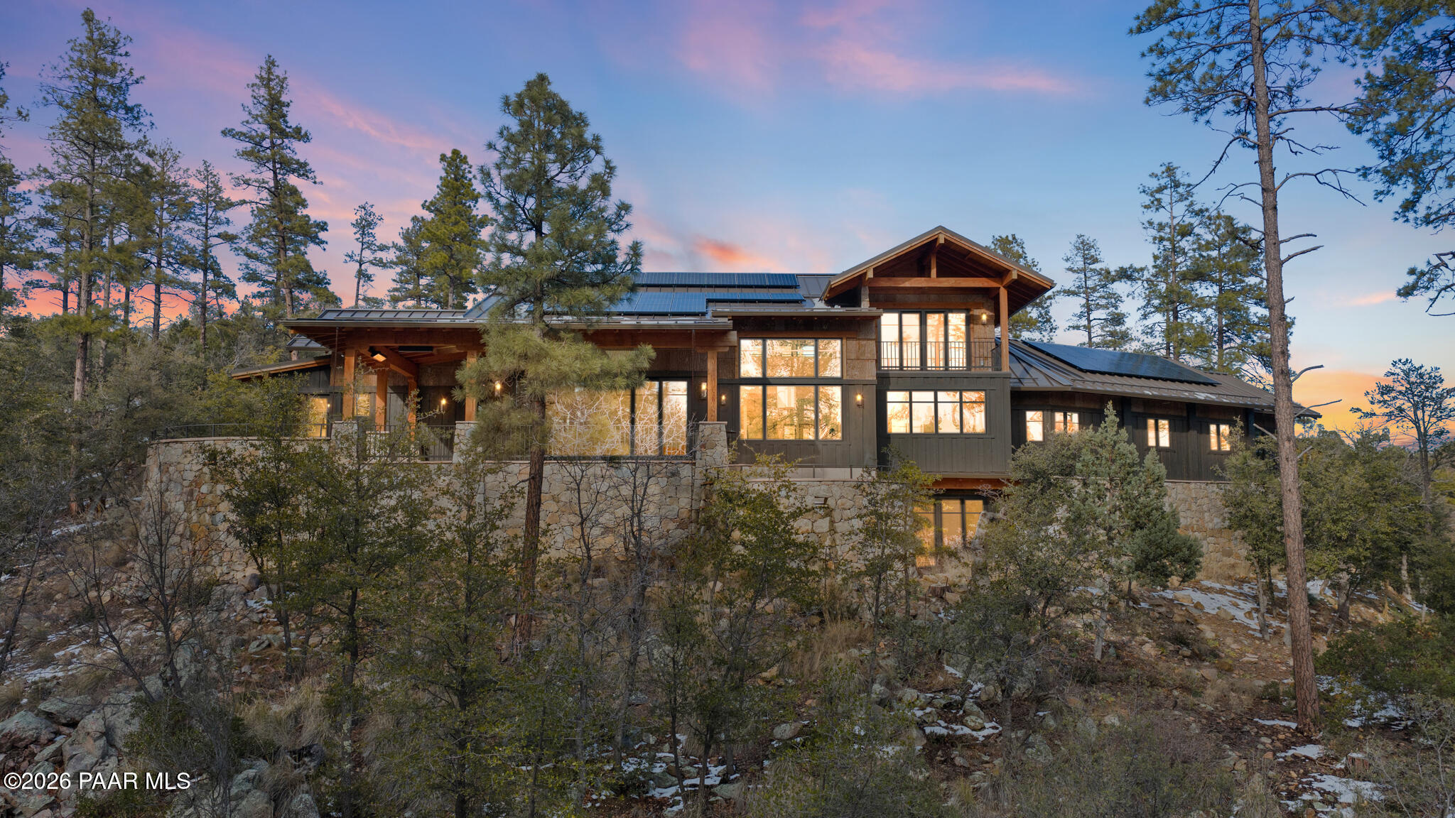 1090 High Valley Ranch Road Prescott, AZ 86303 - Photo 2 of 65 a view of a house with brick walls and flower plants