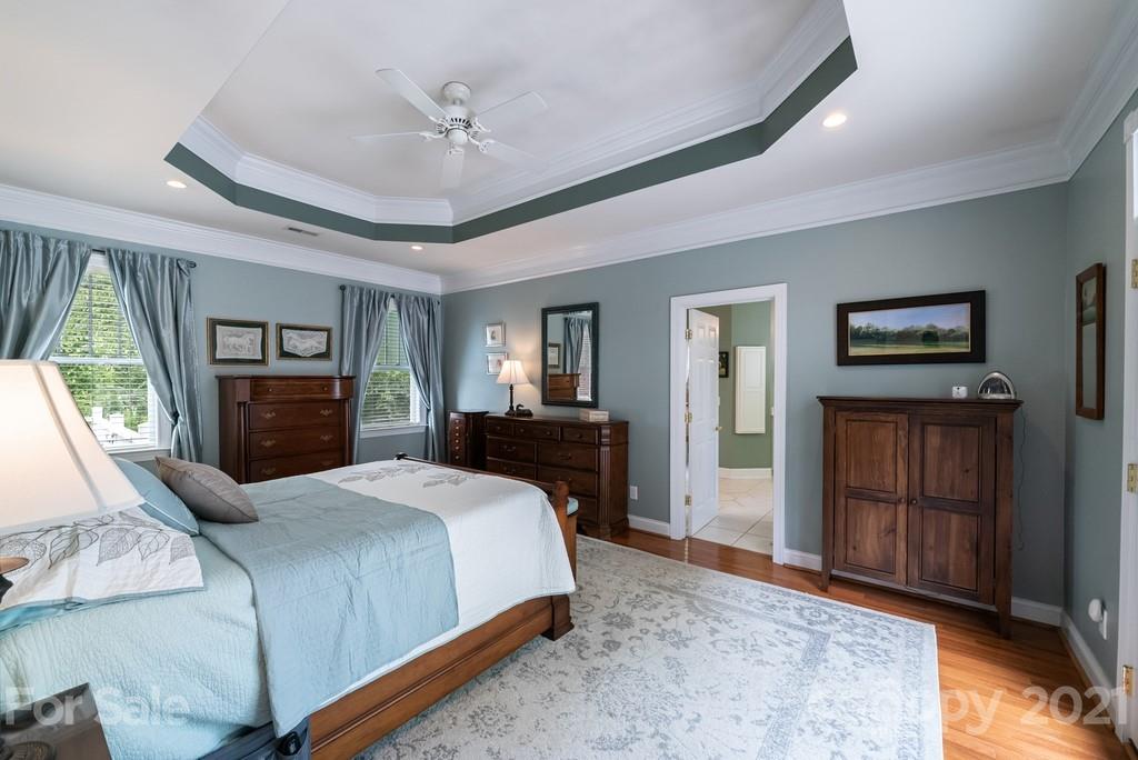 310 Bridle Path Farm Road Cleveland, NC 27013 - Photo 14 of 48 a bedroom with a large bed a flat tv screen and dresser
