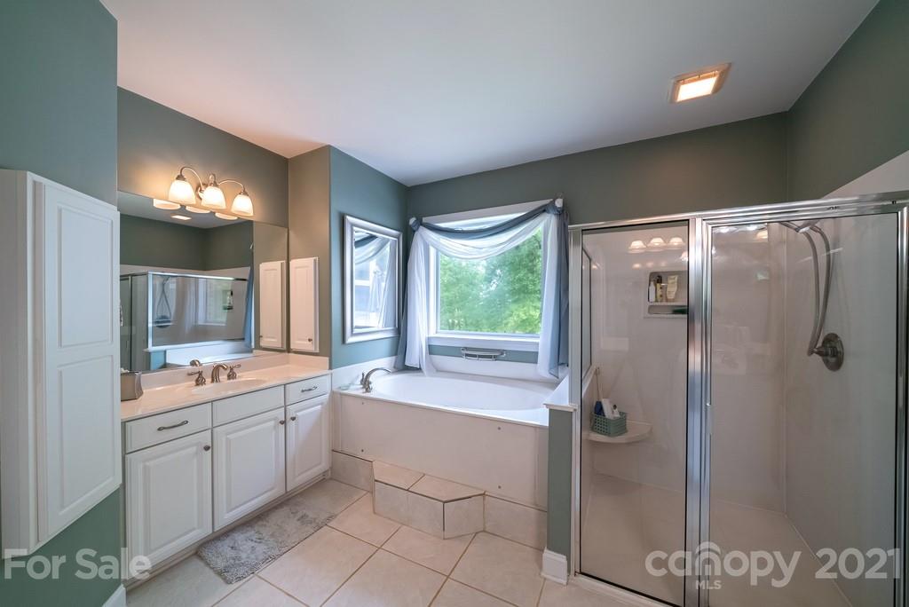 310 Bridle Path Farm Road Cleveland, NC 27013 - Photo 17 of 48 a bathroom with a double vanity sink mirror and shower