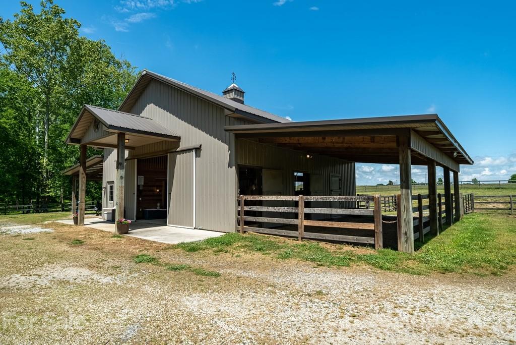 310 Bridle Path Farm Road Cleveland, NC 27013 - Photo 3 of 48 a view of a house with a large window and a yard