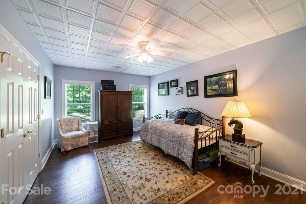 310 Bridle Path Farm Road Cleveland, NC 27013 - Photo 25 of 48 a bedroom with a bed and wooden floor