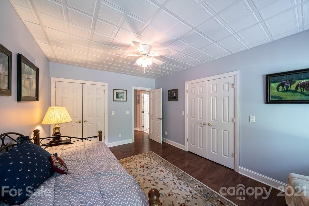 310 Bridle Path Farm Road Cleveland, NC 27013 - Photo 26 of 48 a bedroom with a bed and a chandelier