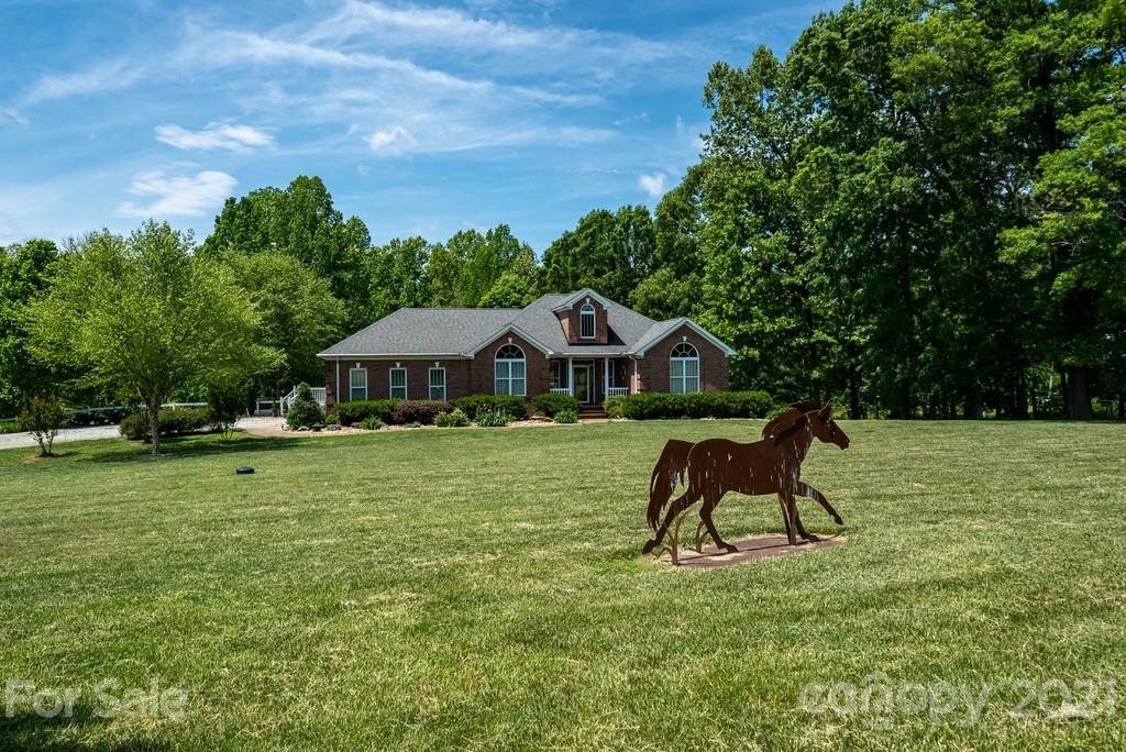 310 Bridle Path Farm Road Cleveland, NC 27013 - Photo 4 of 48 a house view with a garden space