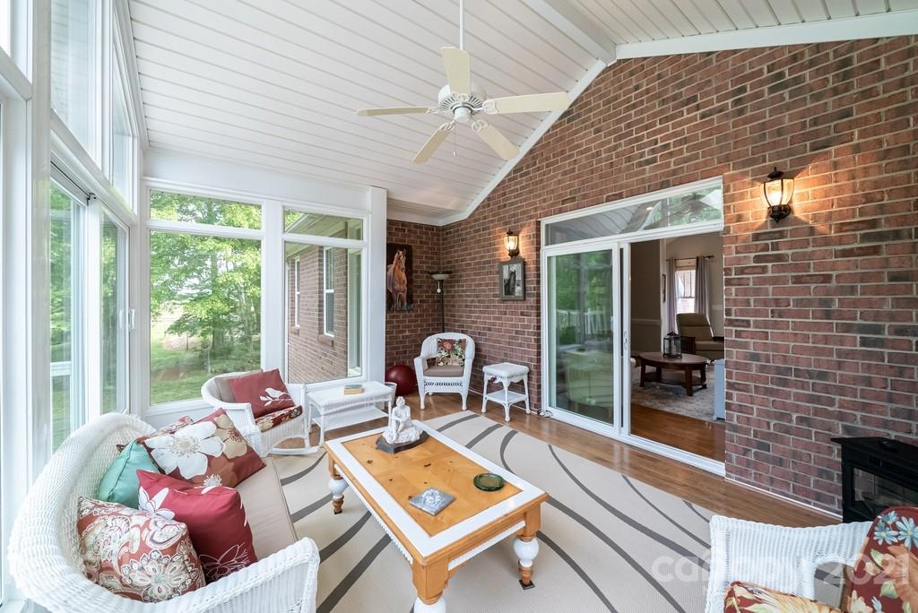 310 Bridle Path Farm Road Cleveland, NC 27013 - Photo 9 of 48 a living room with furniture and floor to ceiling windows