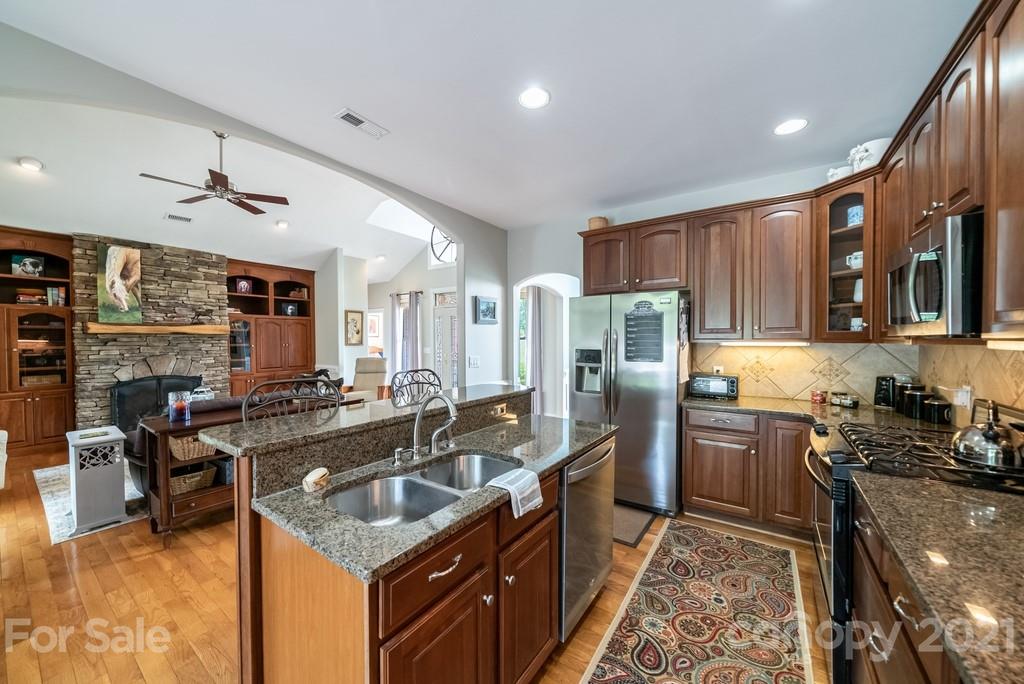 310 Bridle Path Farm Road Cleveland, NC 27013 - Photo 10 of 48 a kitchen with stainless steel appliances granite countertop a sink stove and refrigerator
