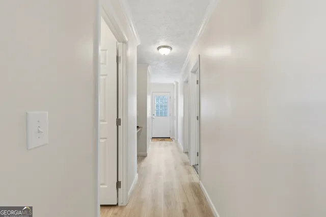 a view of a hallway with wooden floor