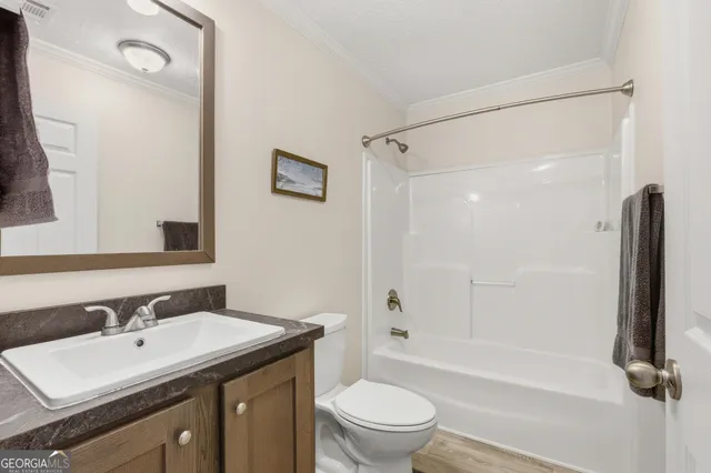 a bathroom with a sink toilet tub and shower