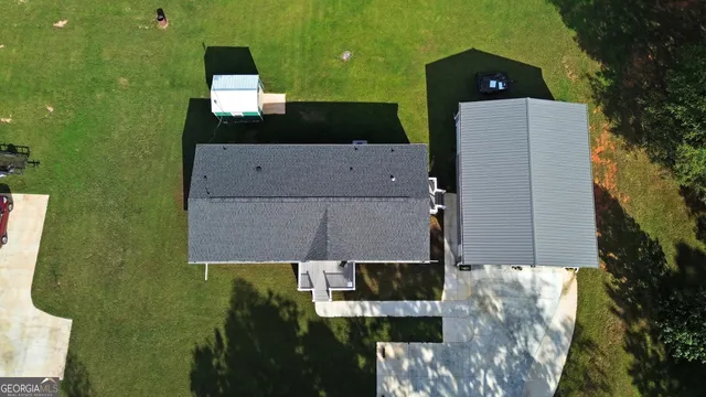 an aerial view of a house with a yard