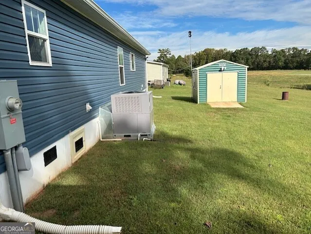 an aerial view of residential houses with outdoor space and trees