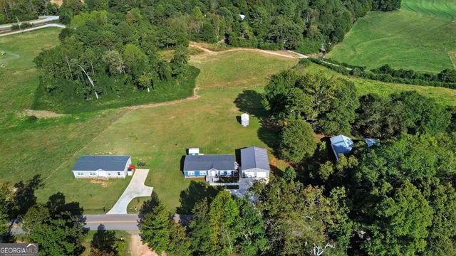an aerial view of a swimming pool with yard